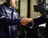 Mechanical engineers repairing engine machine at factory